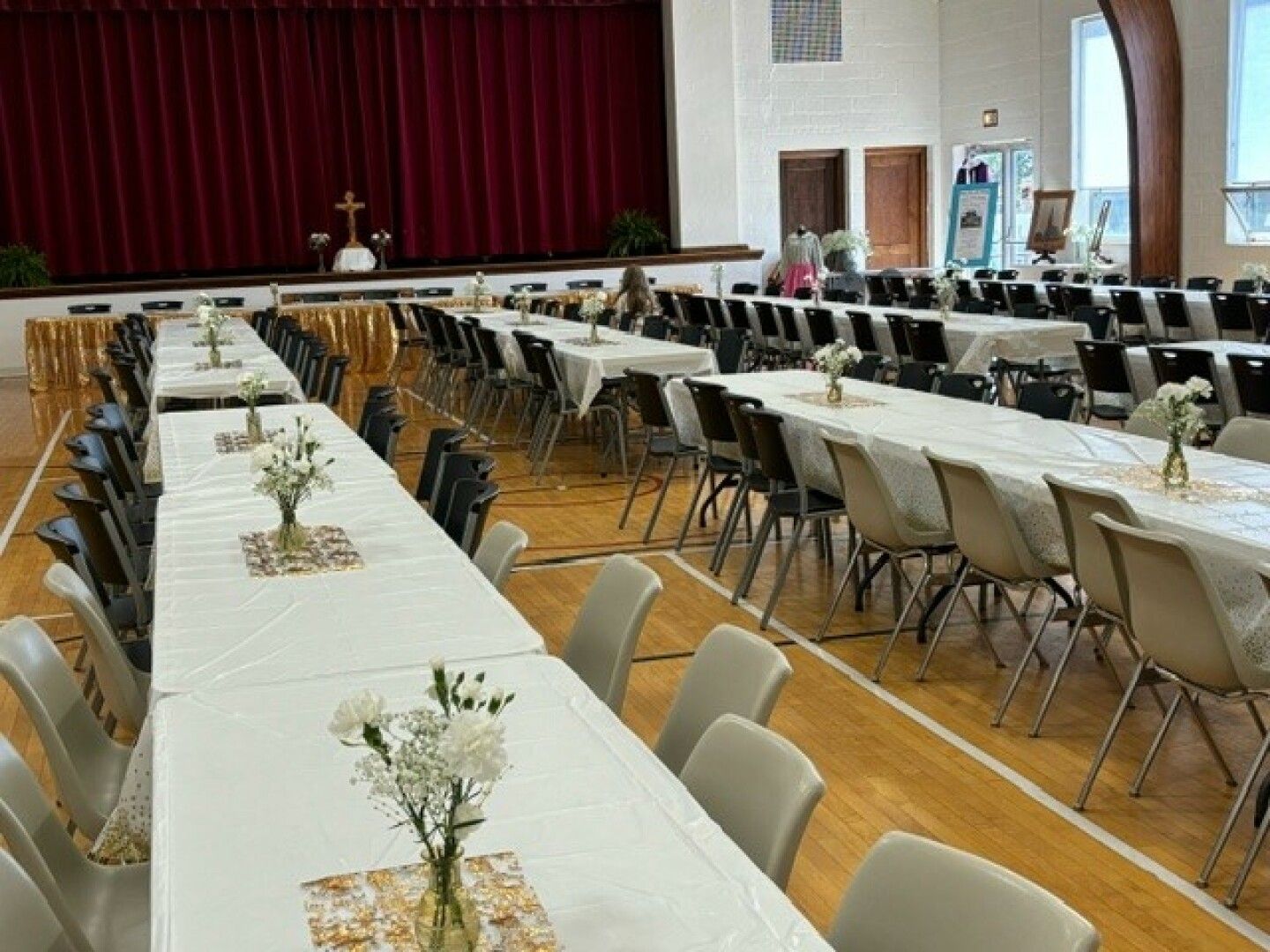 A banquet hall with long tables set for an event. 
