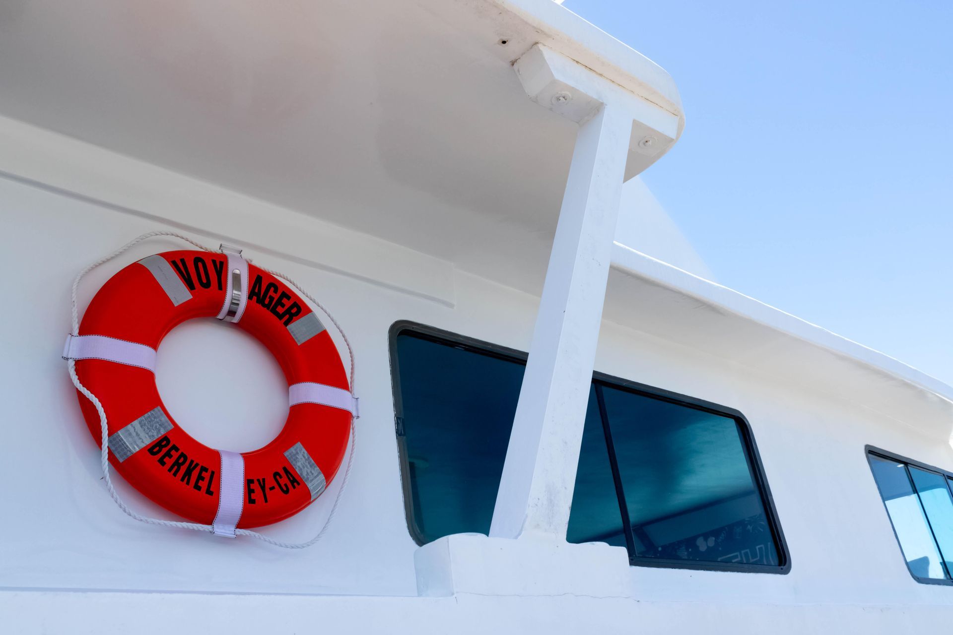 Group of friends toasting champagne on a rooftop at dusk, lit by string lights; joyful expressions.