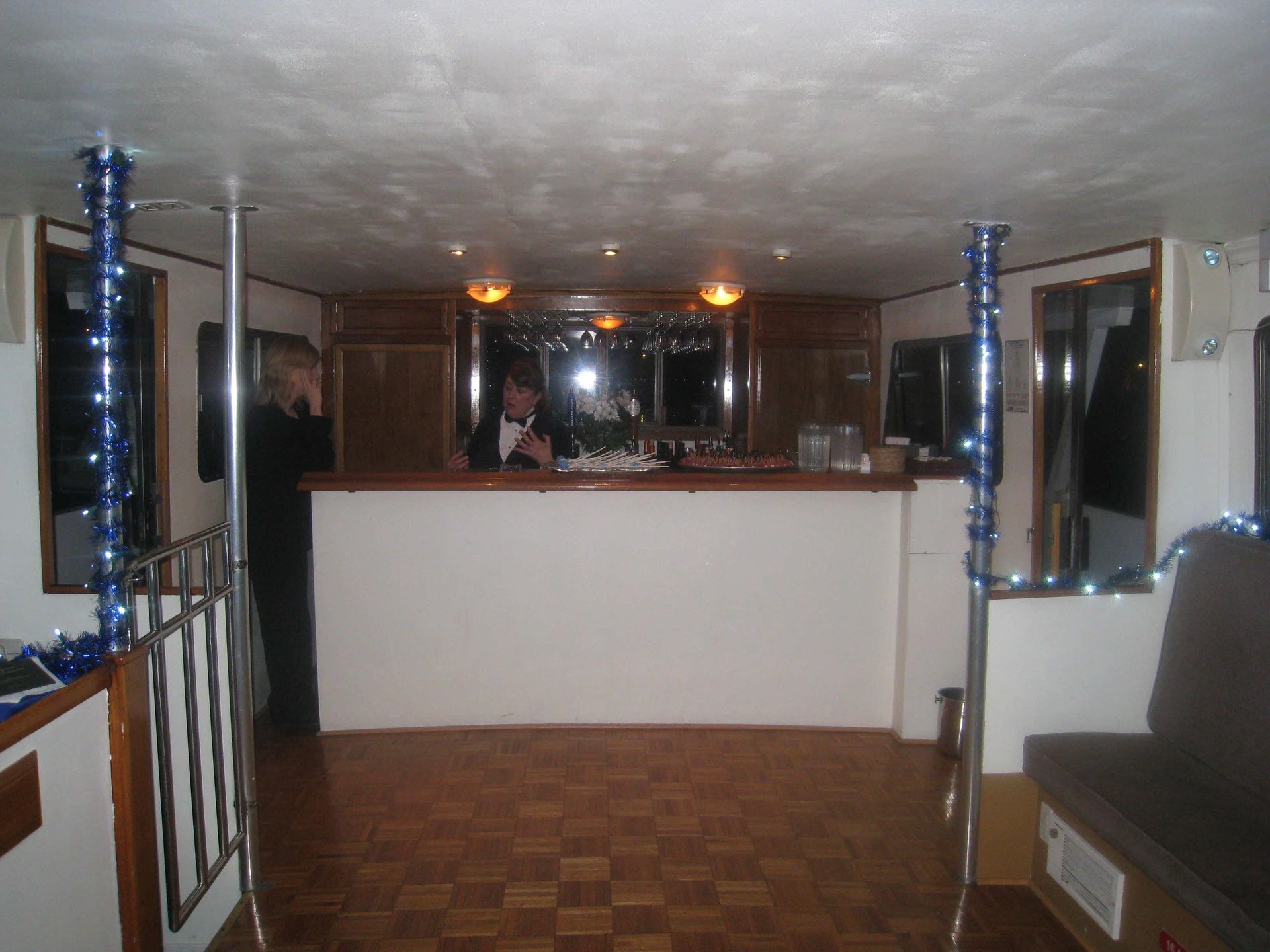 Two champagne flutes on a table, with ocean sunset in the background.