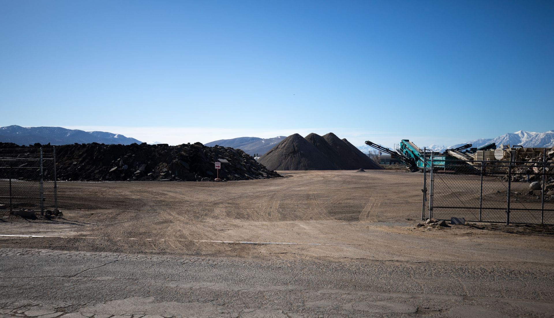 A large pile of dirt is sitting in the middle of a dirt field.