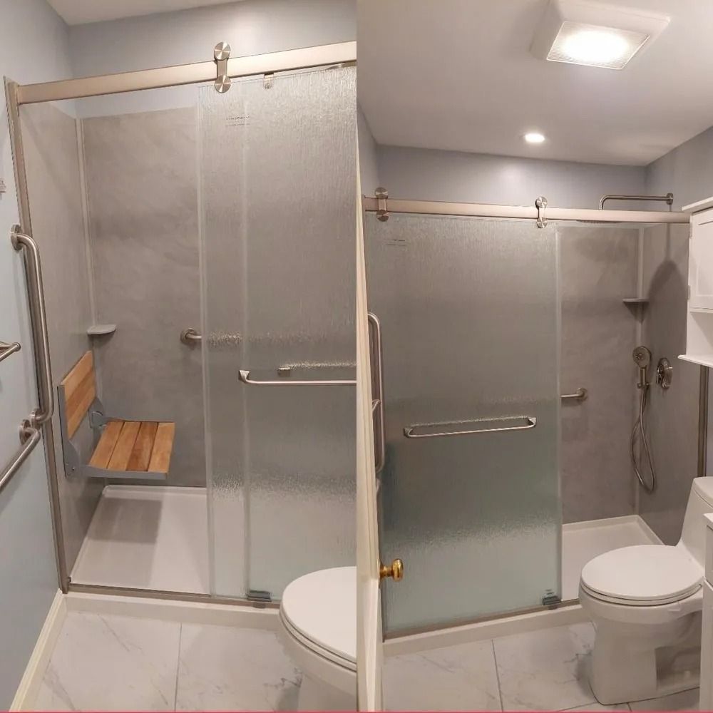 Accessible bathroom with glass shower, grab bars, bench seat, and toilet, shown in a bright white interior