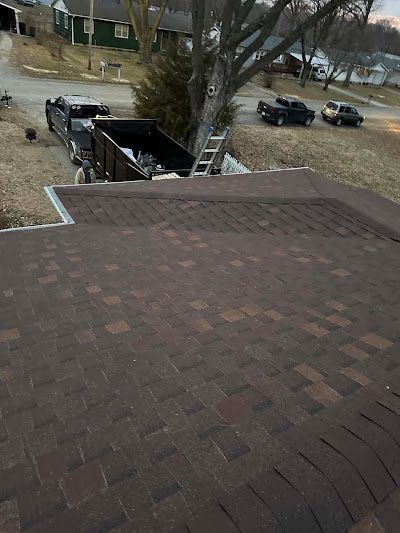 A truck is parked on the roof of a house.