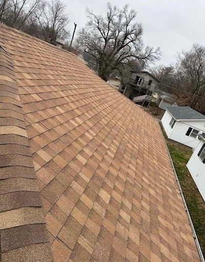 A close up of a roof with a lot of shingles on it.