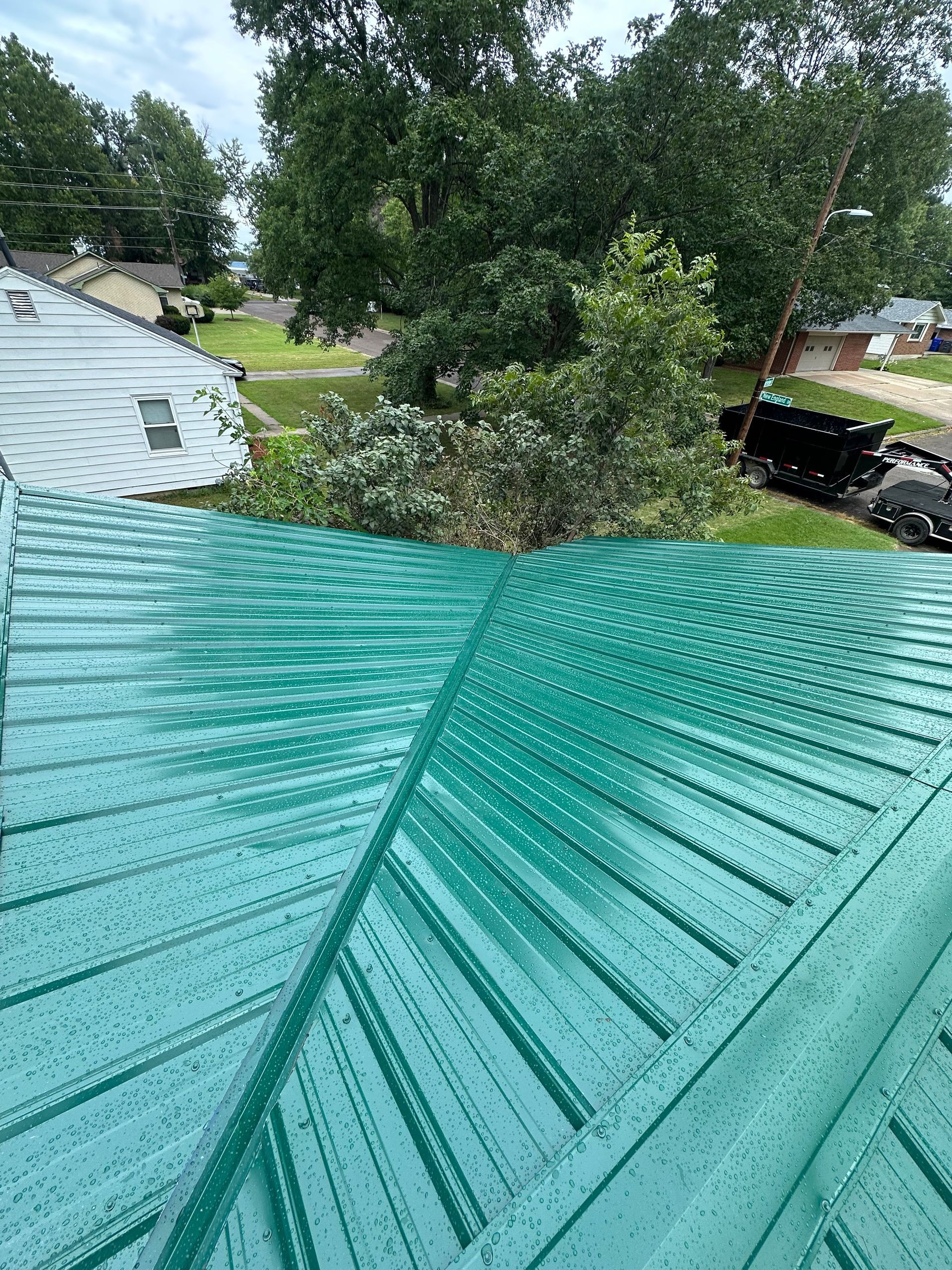 A house with a roof that has shingles on it and an air conditioner on the side of it.