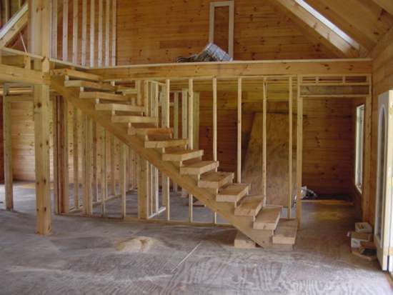 Interior view of wooden staircase under construction in a new building.
