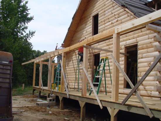 Construction of a log cabin porch.