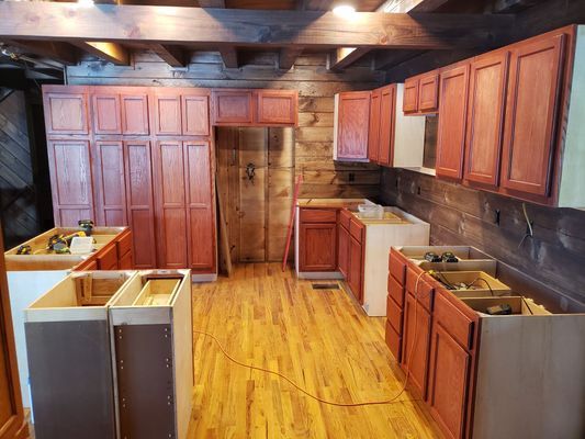 Kitchen remodel in progress with new wood cabinets.