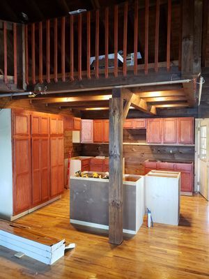 Kitchen remodel: Red cabinets, wood floors, and a loft.