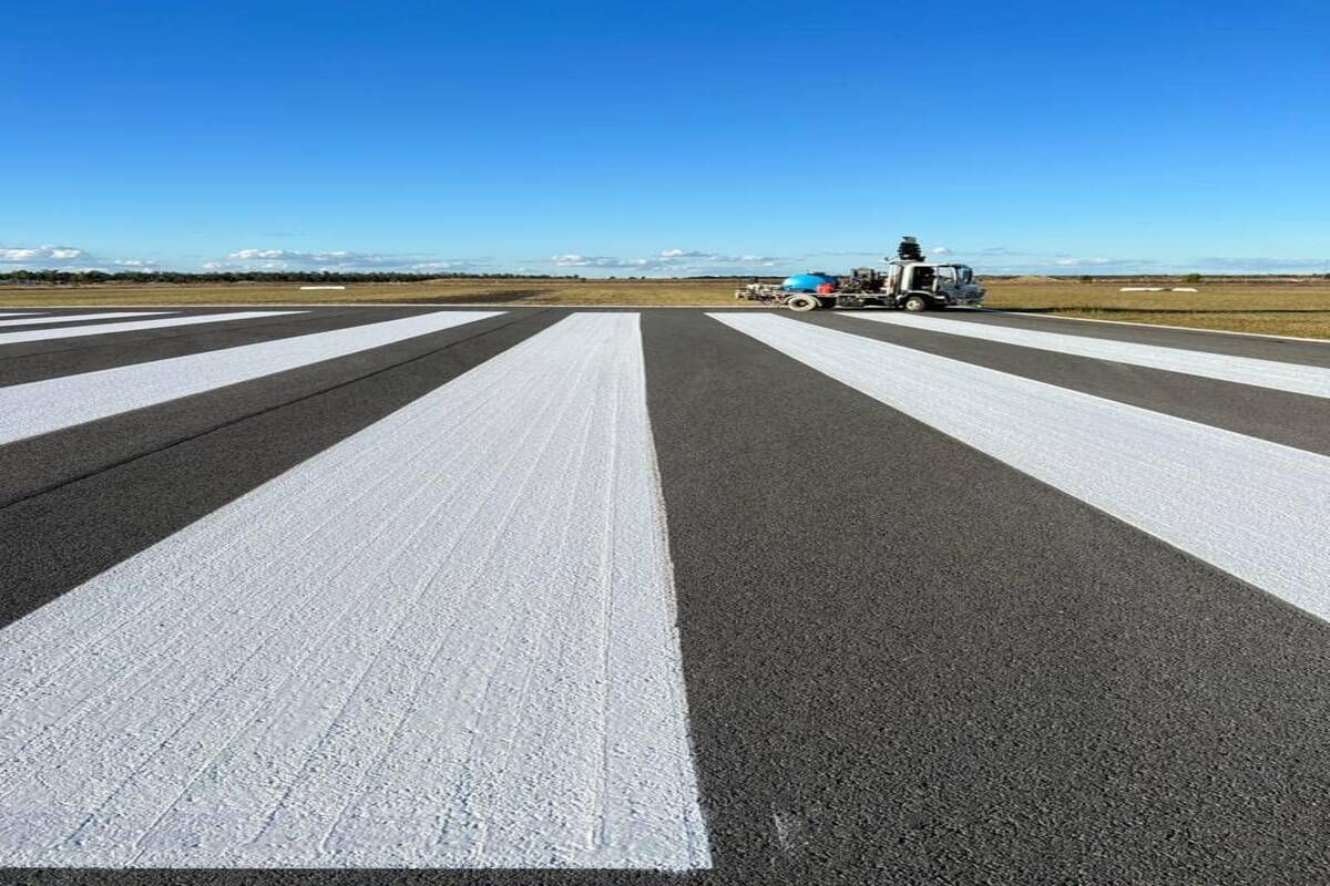 A Plane Is Parked On The Runway Of An Airport — Spraywayz Linemarking Pty Ltd In Booral, QLD