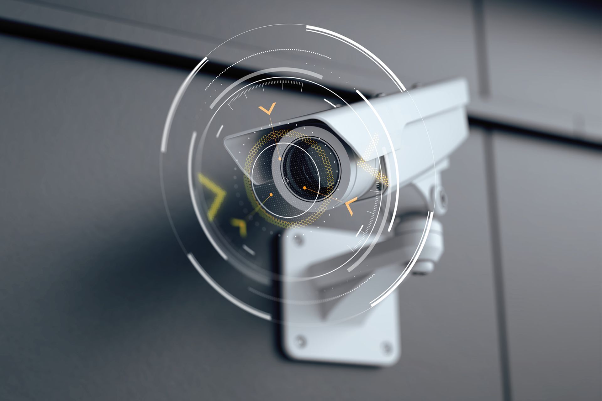 White security camera mounted on a gray wall