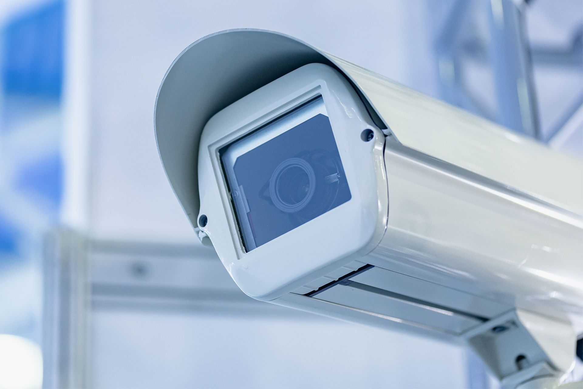 Close-up of a security camera mounted on a wall