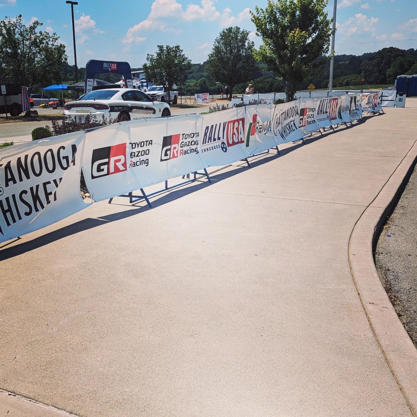 A row of signs on a sidewalk that say gr hiskey