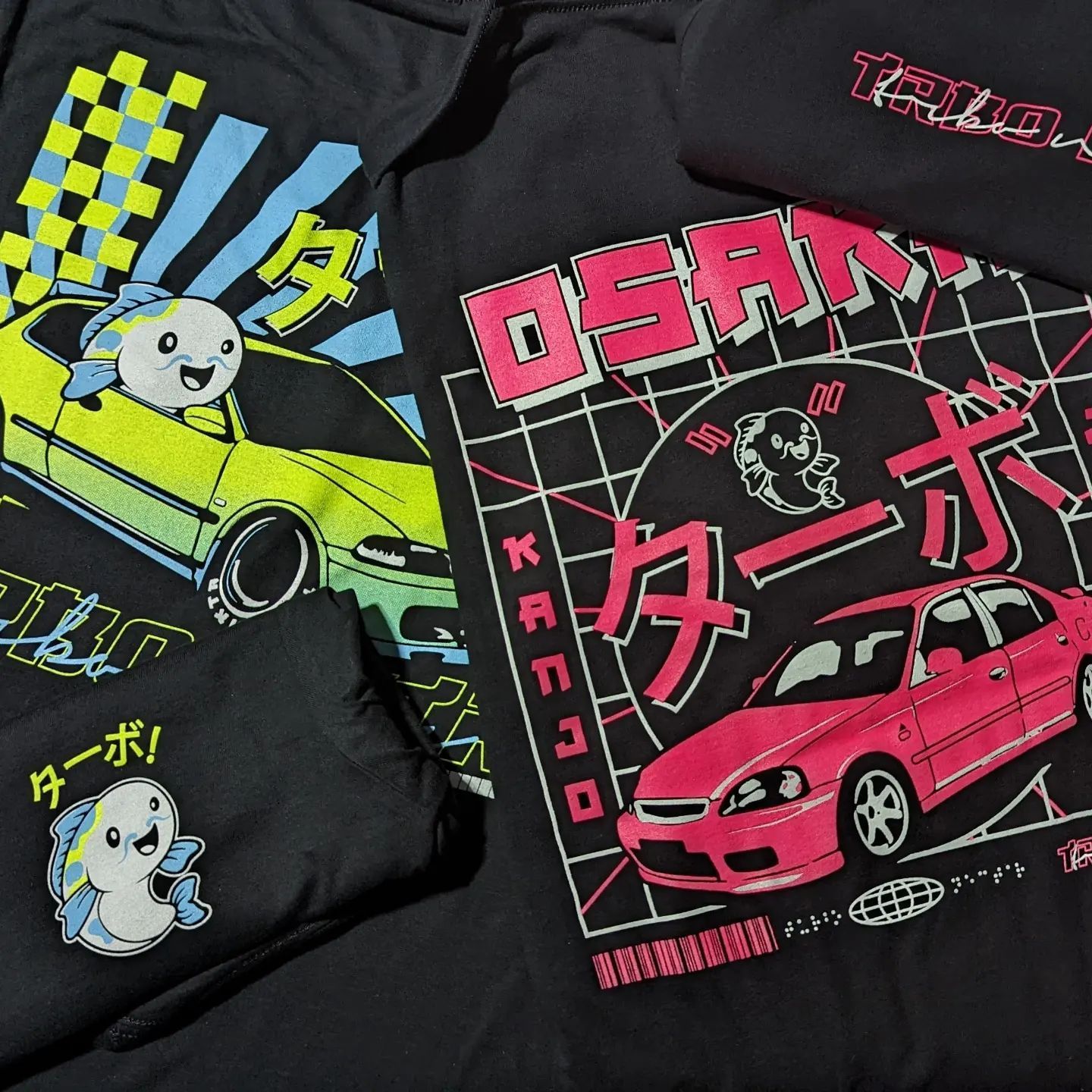 A black shirt with a pink car and the word osaka on it