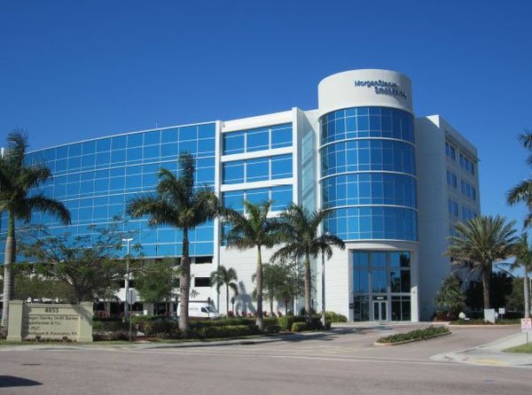 A large building with palm trees in front of it