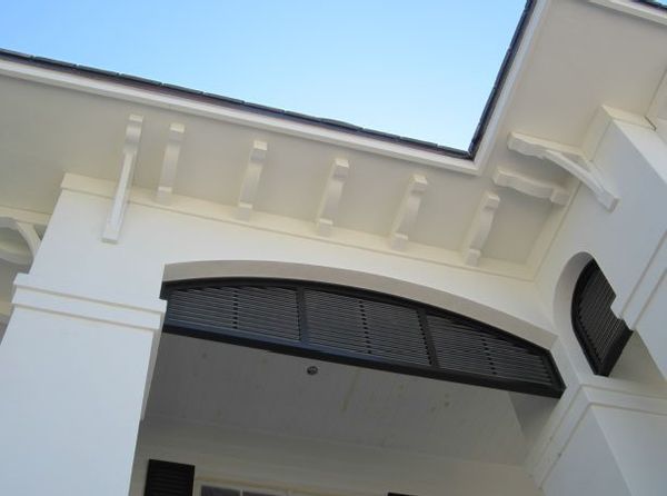 Looking up at a white building with a blue sky in the background