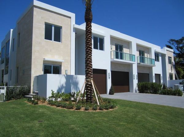 A house with a palm tree in front of it