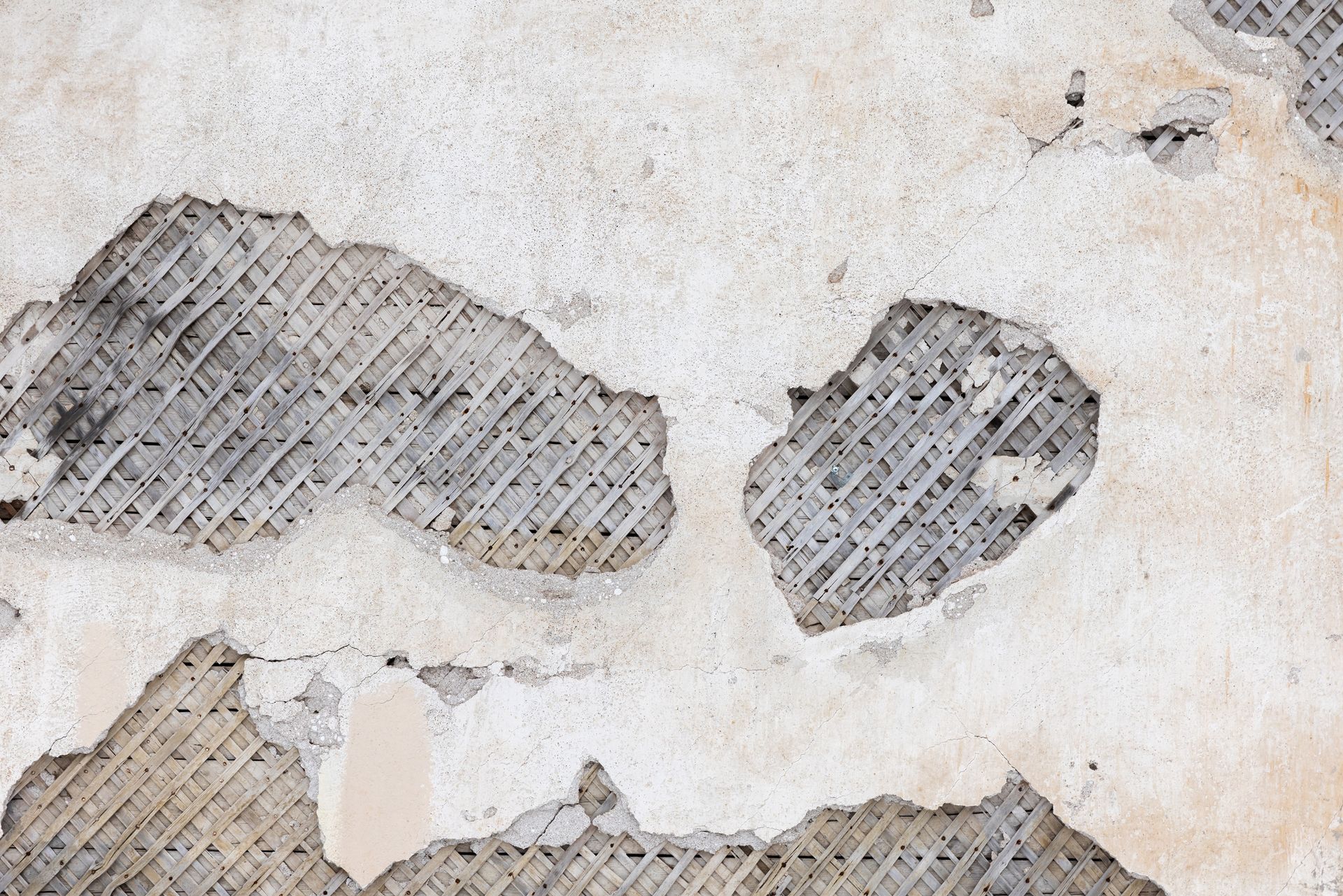 A close up of a concrete wall with a lot of holes in it