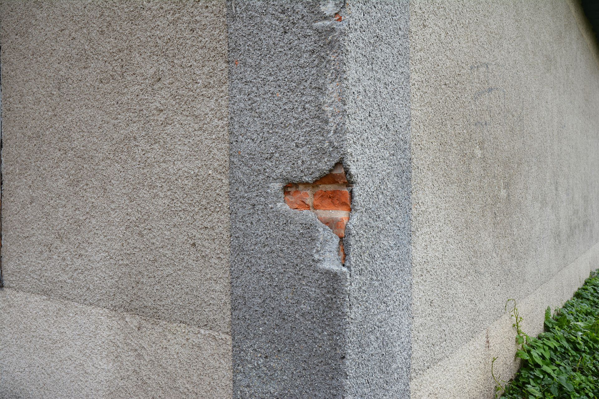 A close up of a stone wall with a hole in it.