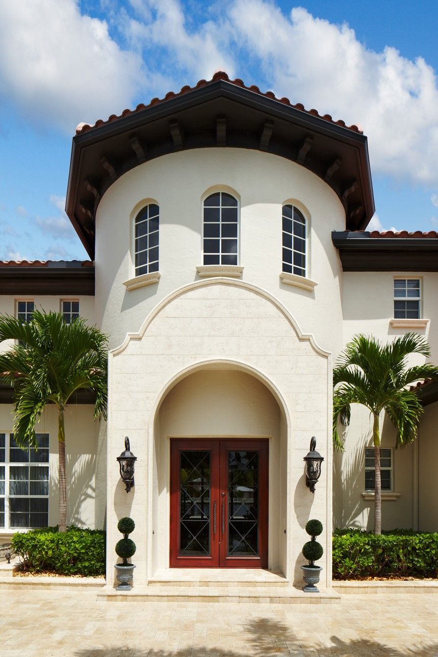 A house with arched windows and a garage door