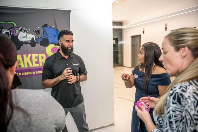 A man is talking to a group of people in a room.