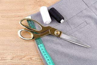 Business suit on the table with scissors, ruler and strings