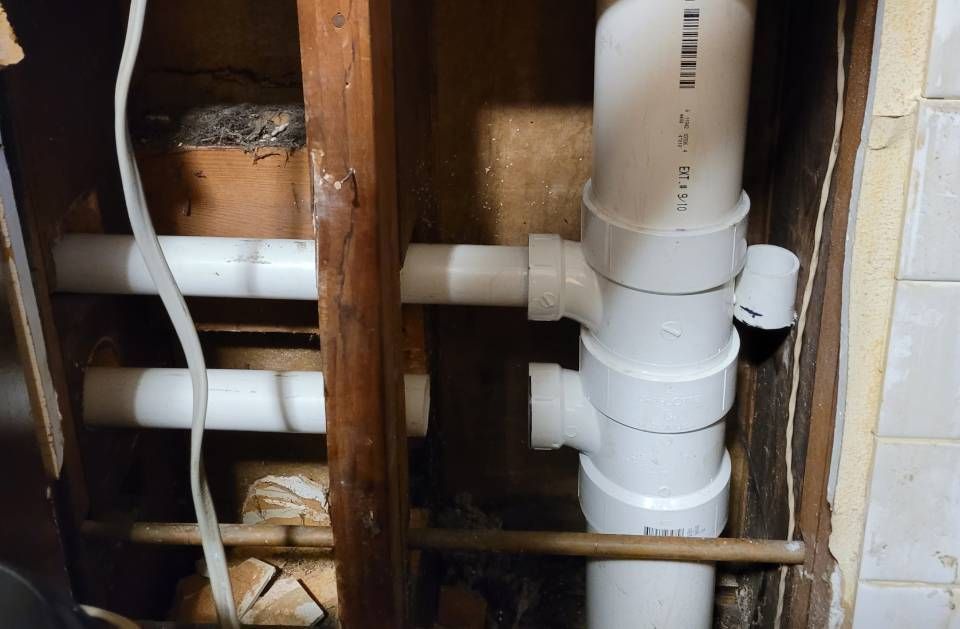 A bunch of white pipes are stacked on top of each other