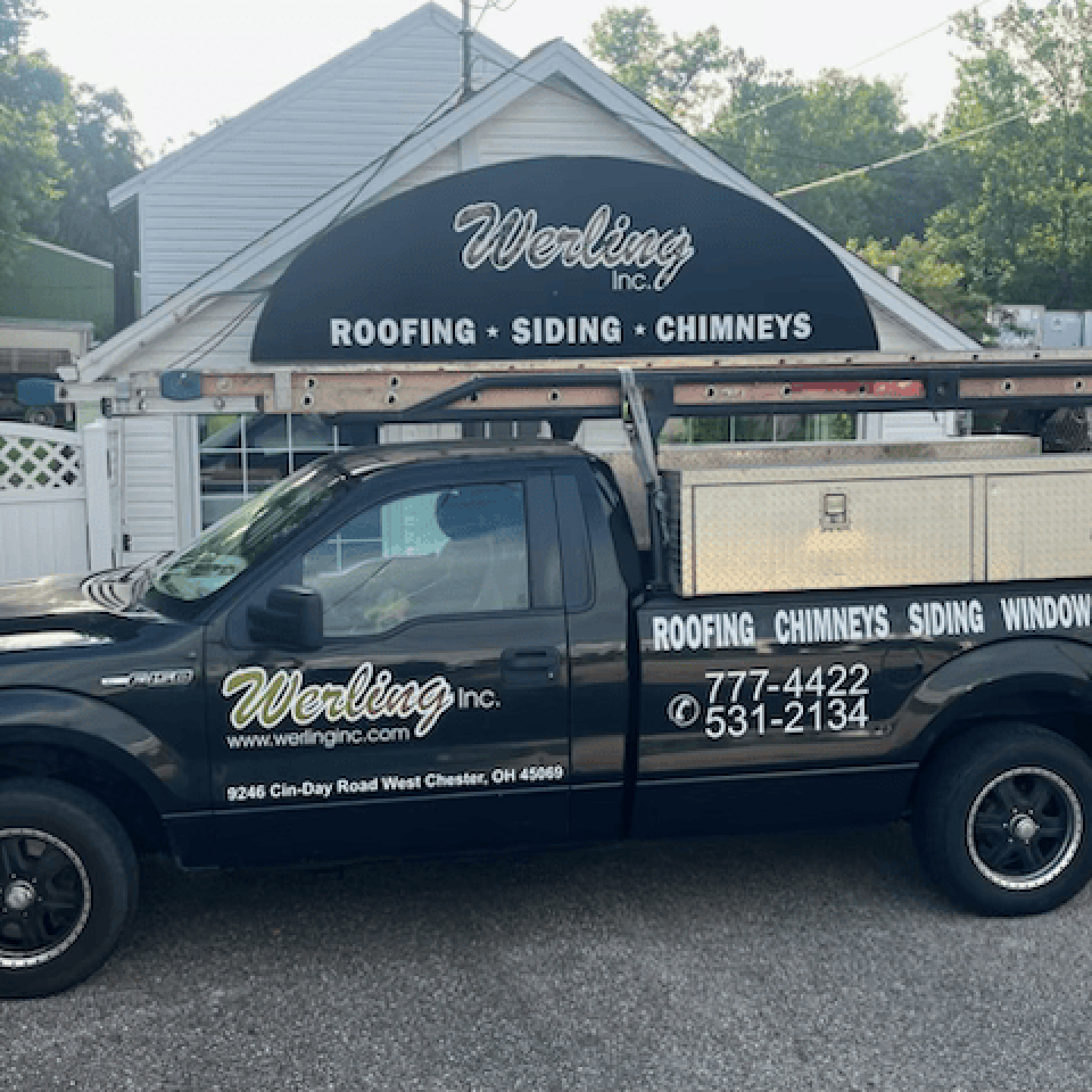 Black pickup truck with the Worling Inc. logo in front of a building. It's a roofing and home repair business.