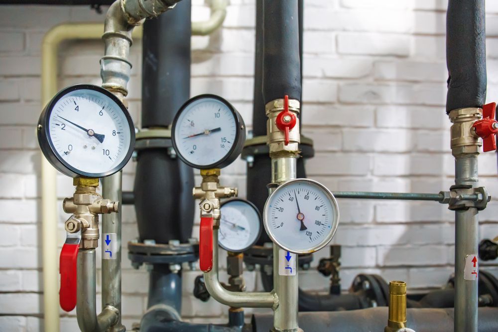 Industrial Setup Featuring Multiple Analog Pressure Gauges, Metal Pipes — Dunnrite Plumbing Services in Airlie Beach, QLD