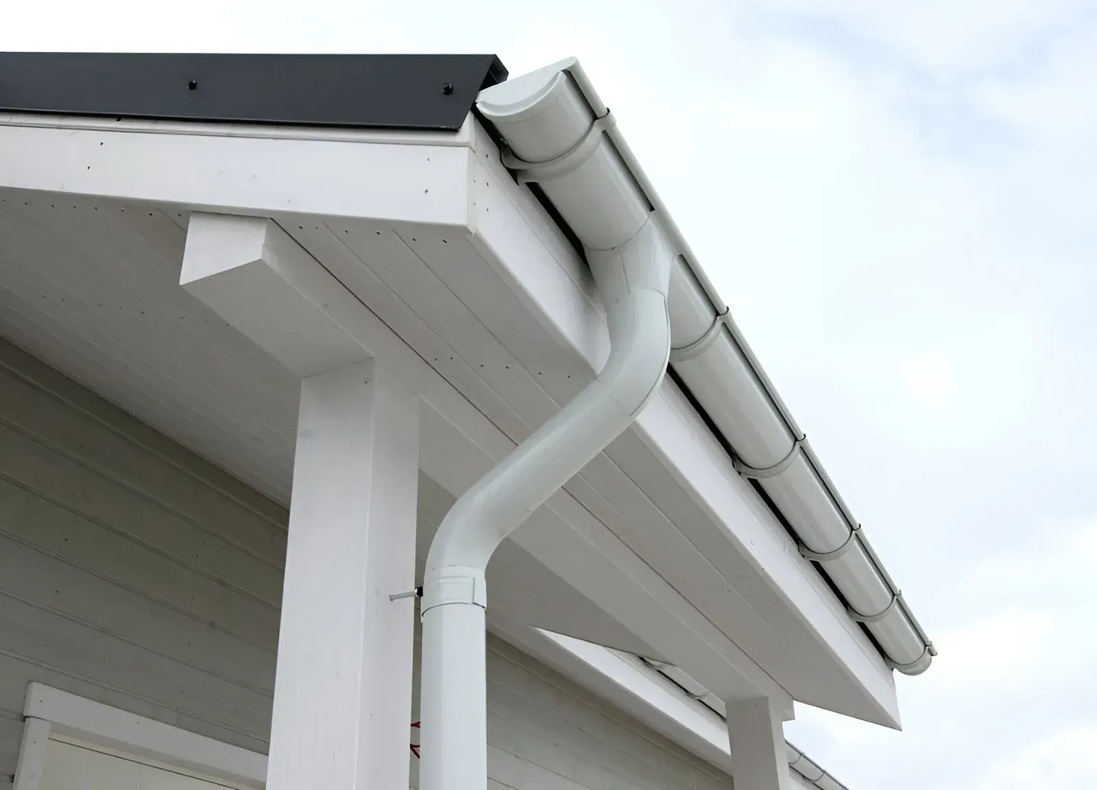 White Roof Gutter and Downspout Installed — Dunnrite Plumbing Services in Cannonvale, QLD