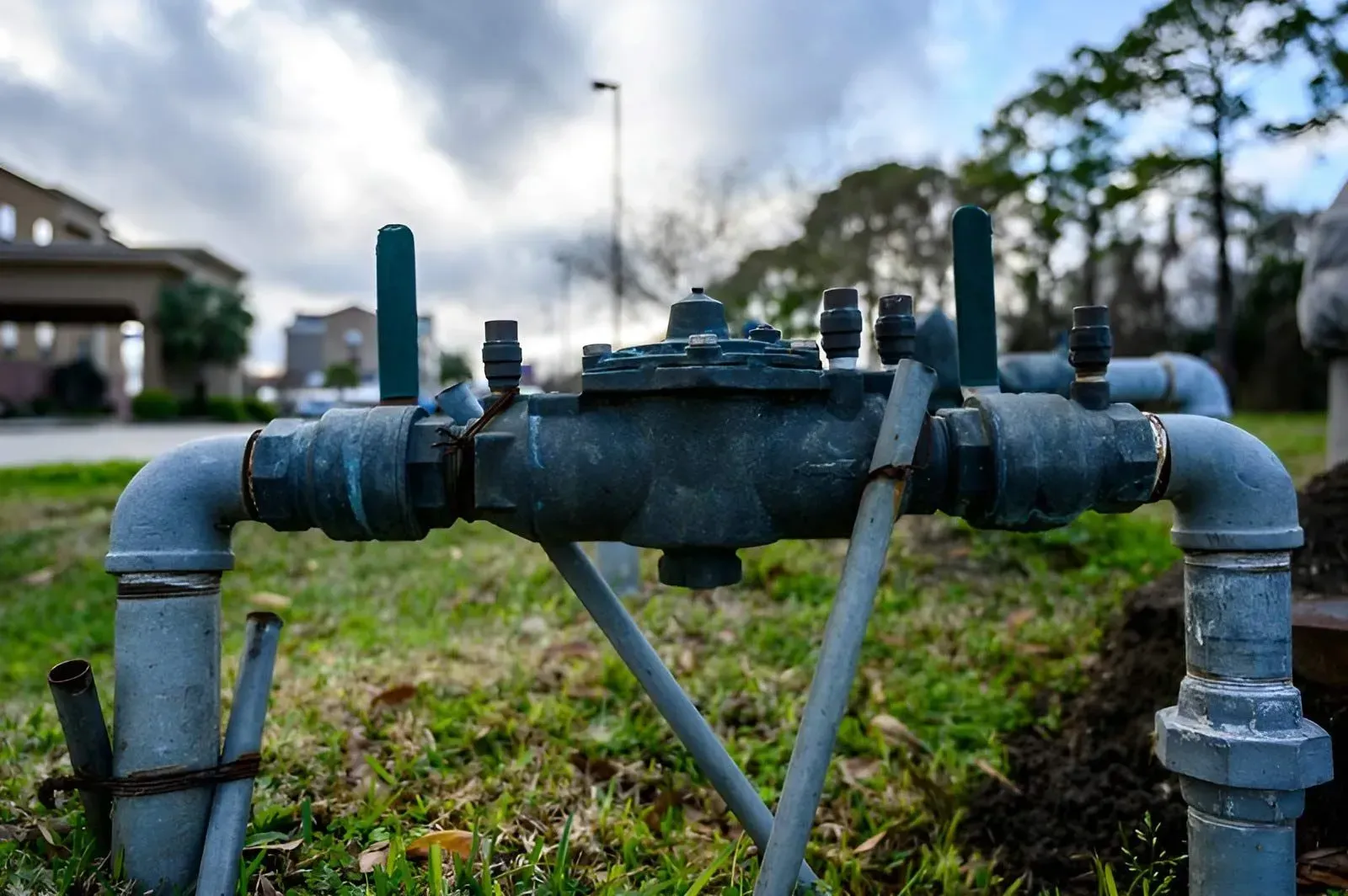 A Metal Backflow Prevention Assembly Connected to Pipes — Dunnrite Plumbing Services in Cannonvale, QLD