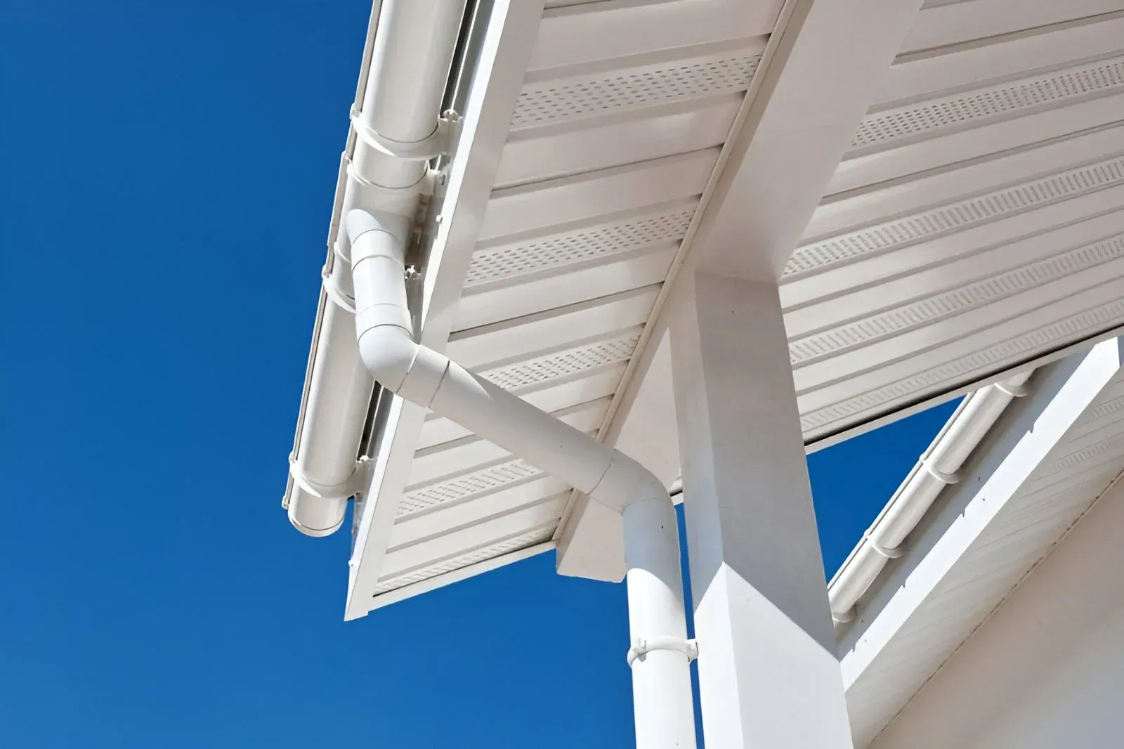 A Low-Angle View of White Roof Gutters — Dunnrite Plumbing Services in Proserpine, QLD