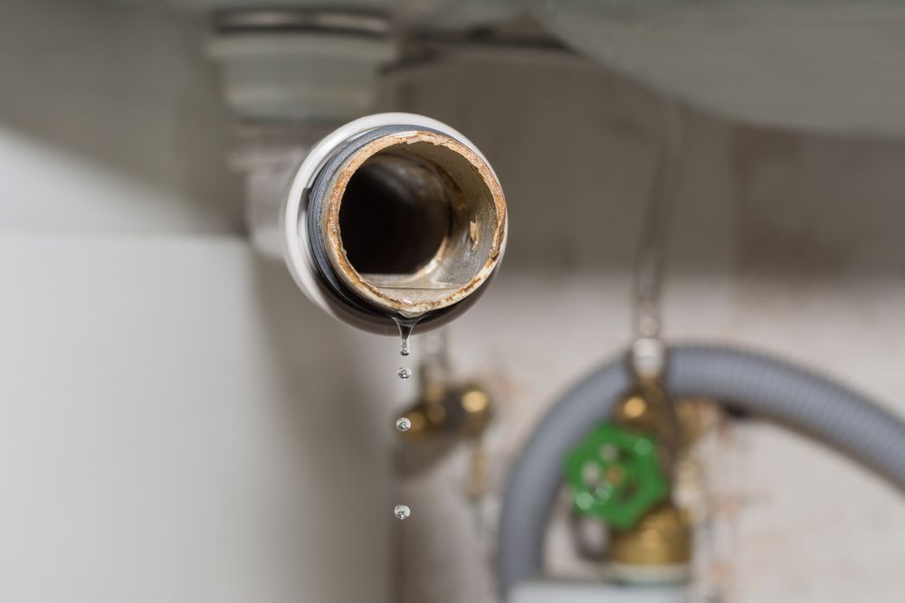 A Close-up of a Disconnected White Drain Pipe — Dunnrite Plumbing Services in Cannonvale, QLD