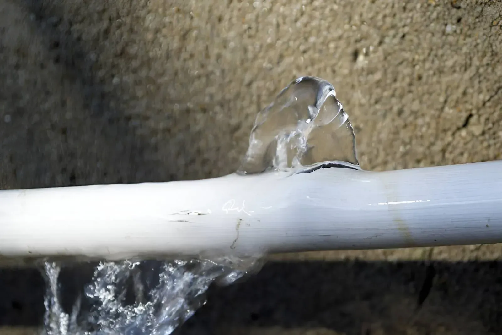 A White Pipe Leaking Water from A Crack — Dunnrite Plumbing Services in Proserpine, QLD