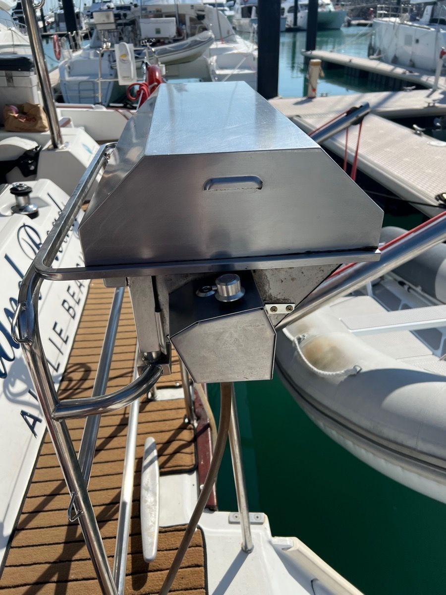 A Stainless Steel Boat Grill Mounted on the Stern Railing of a Boat — Dunnrite Plumbing Services in Cannonvale, QLD
