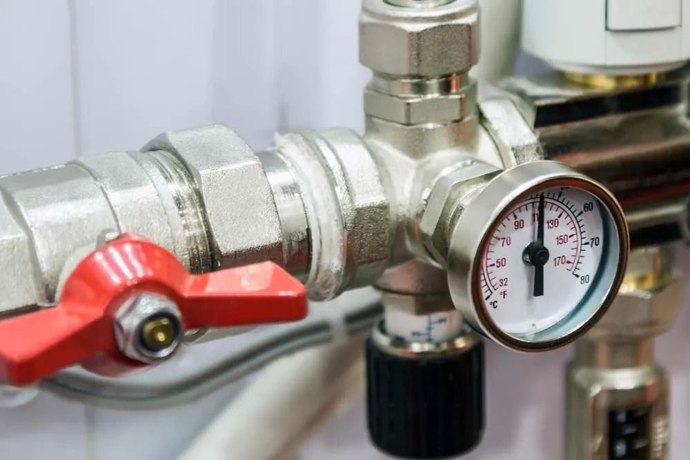 Close-up of a Plumbing Manifold Featuring a Round Pressure Gauge — Dunnrite Plumbing Services in Cannonvale, QLD
