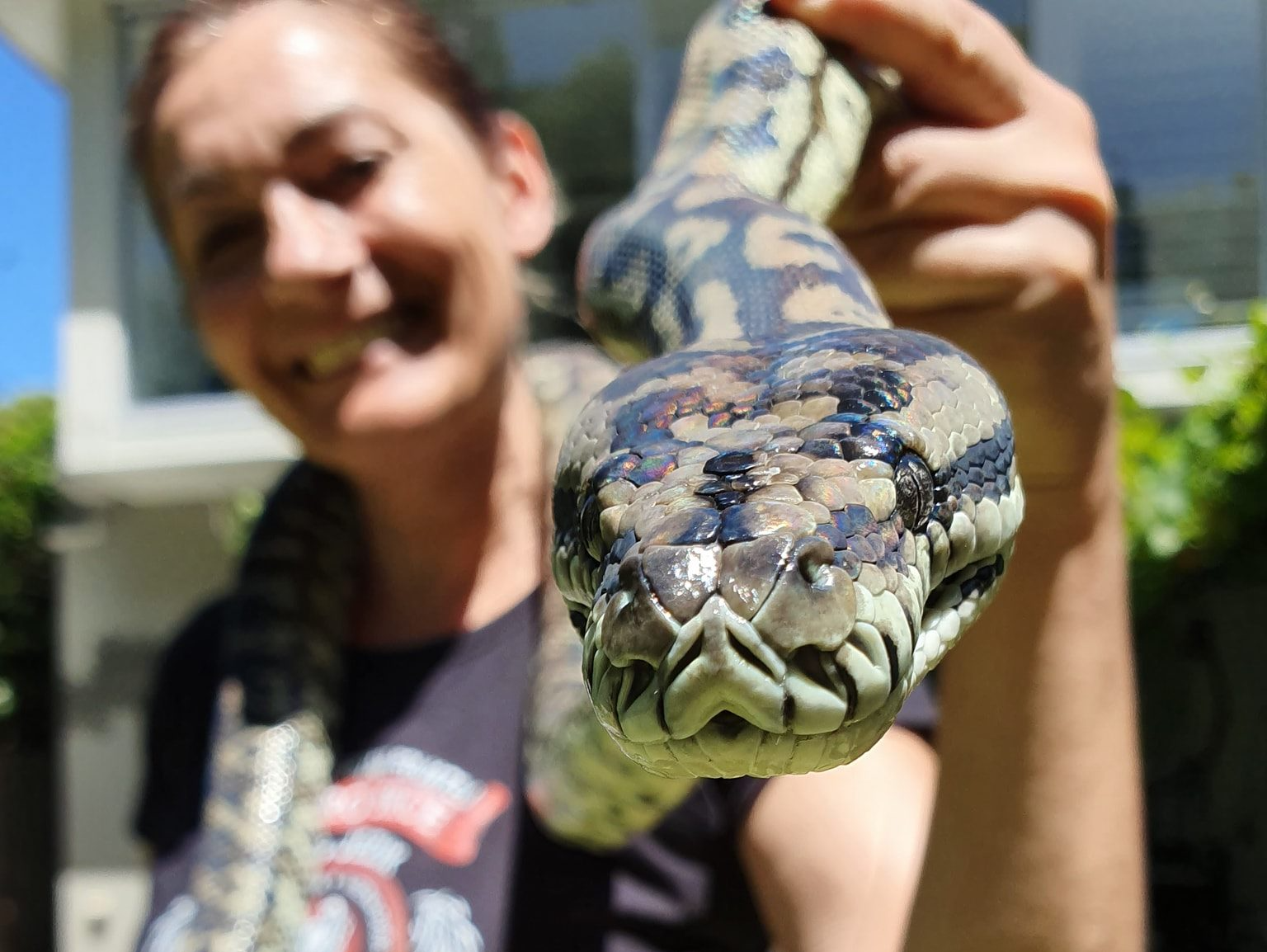 father and daughter holding a snake