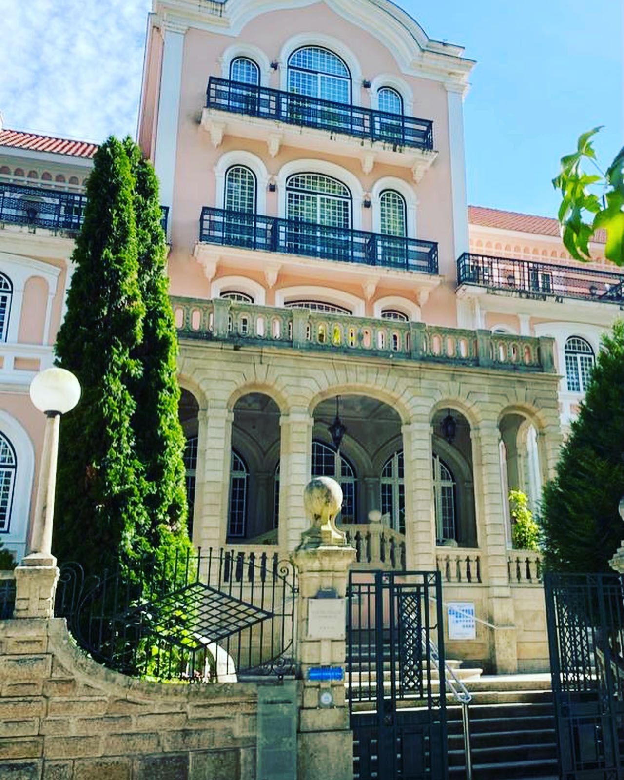 Pink, Ornate Multi-Story Building with Arched Entrance and Balconies β O Tuga Tastes Of Portugal In Melbourne, VIC