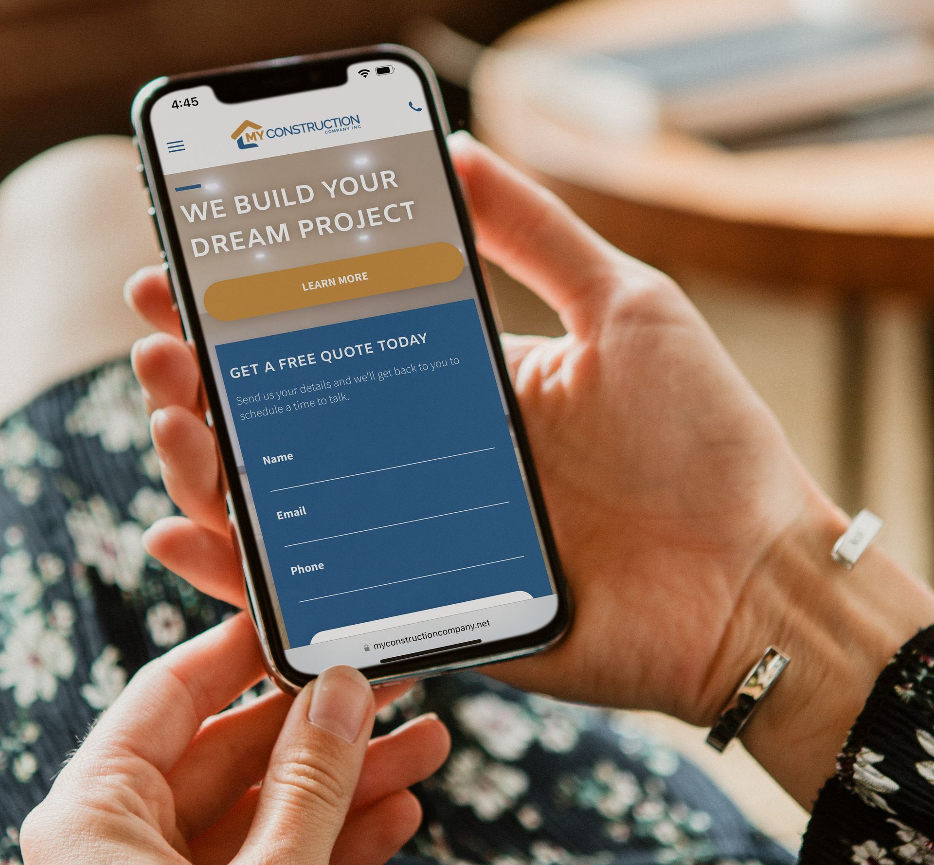 A person is holding a cell phone that says we build your dream project