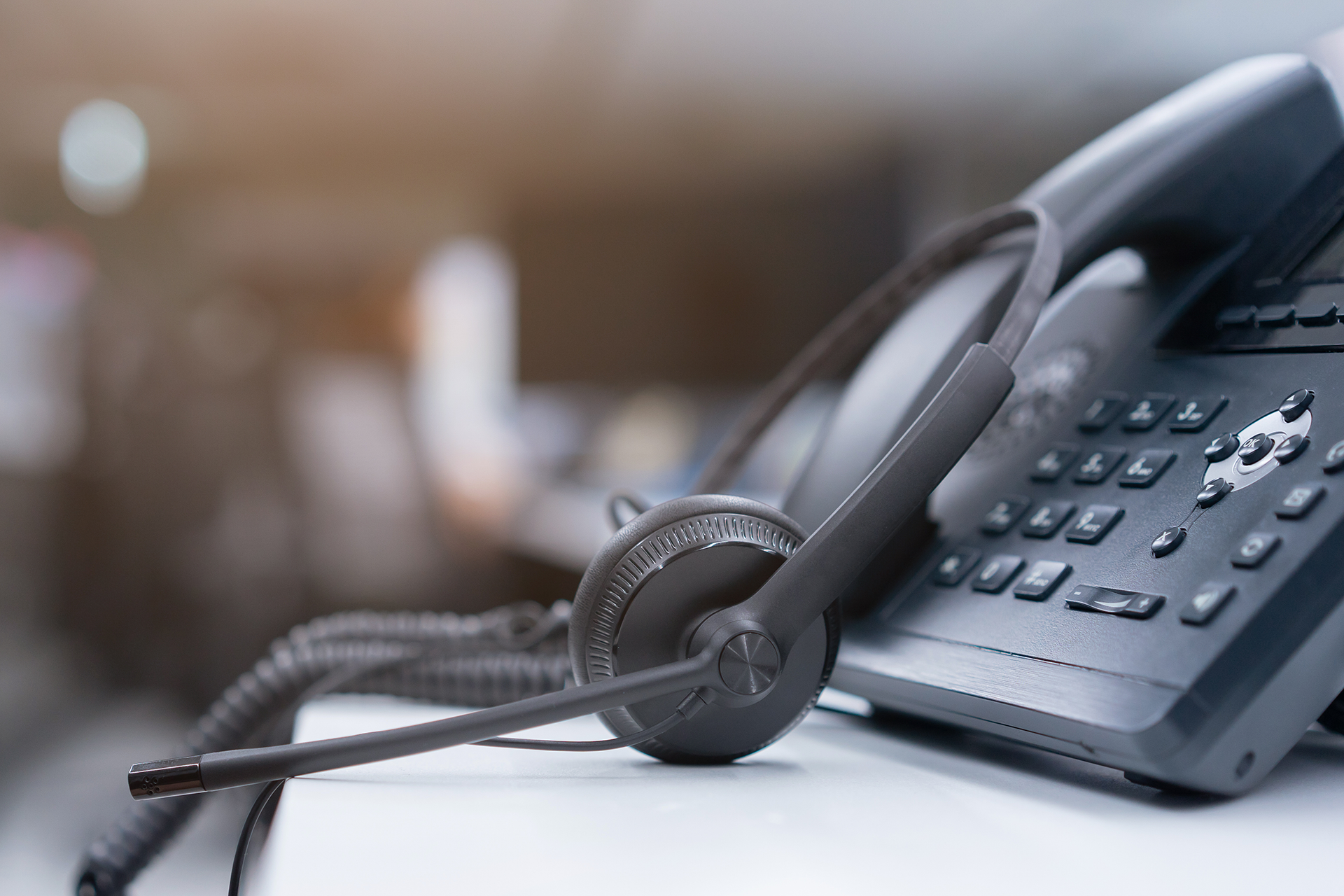 a close up of a business telephone with a headset attached to it .