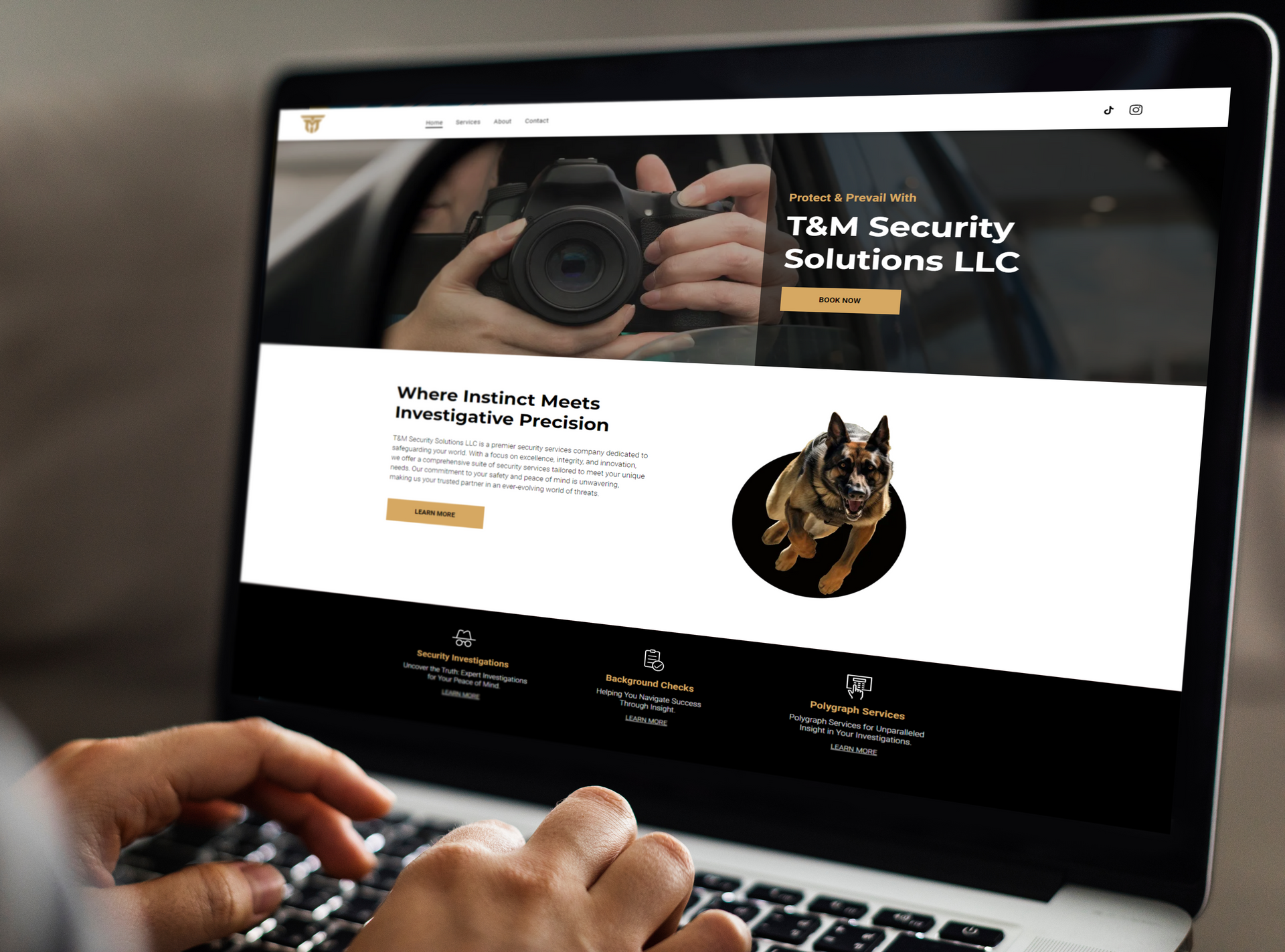 A person has a laptop on their lap open the homepage of the T&M Security website