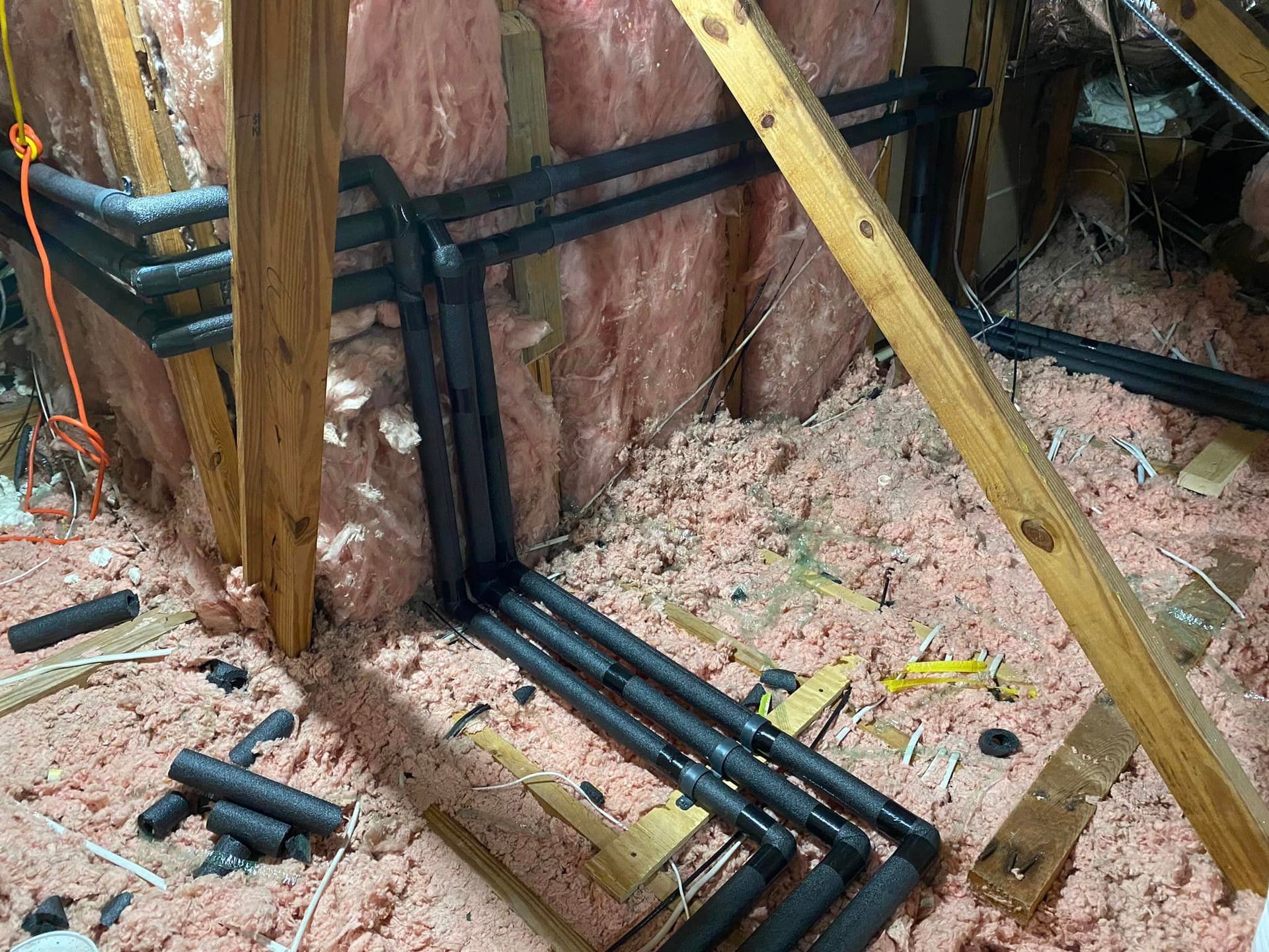 A bunch of pipes are connected to a wall in a room.