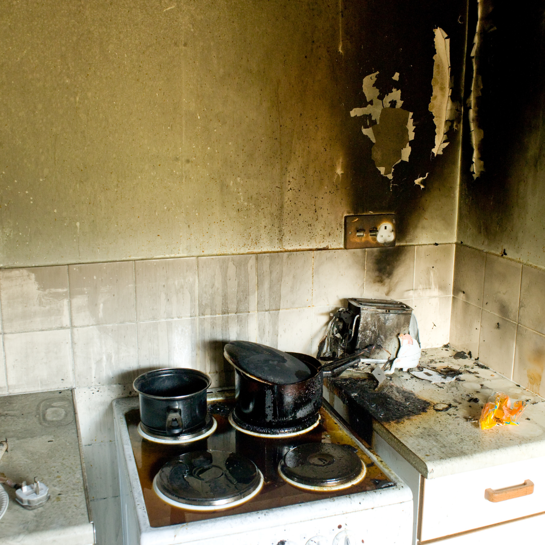 A kitchen with pots and pans on the stove top