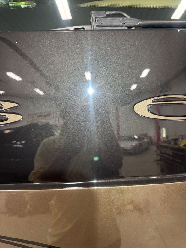 The hood of a car is covered in dust and dirt