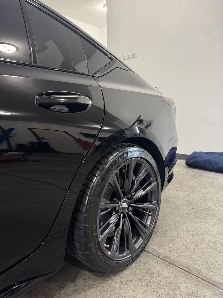 A black car is parked in a garage.