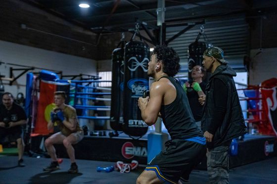 A group of men are boxing in a gym.