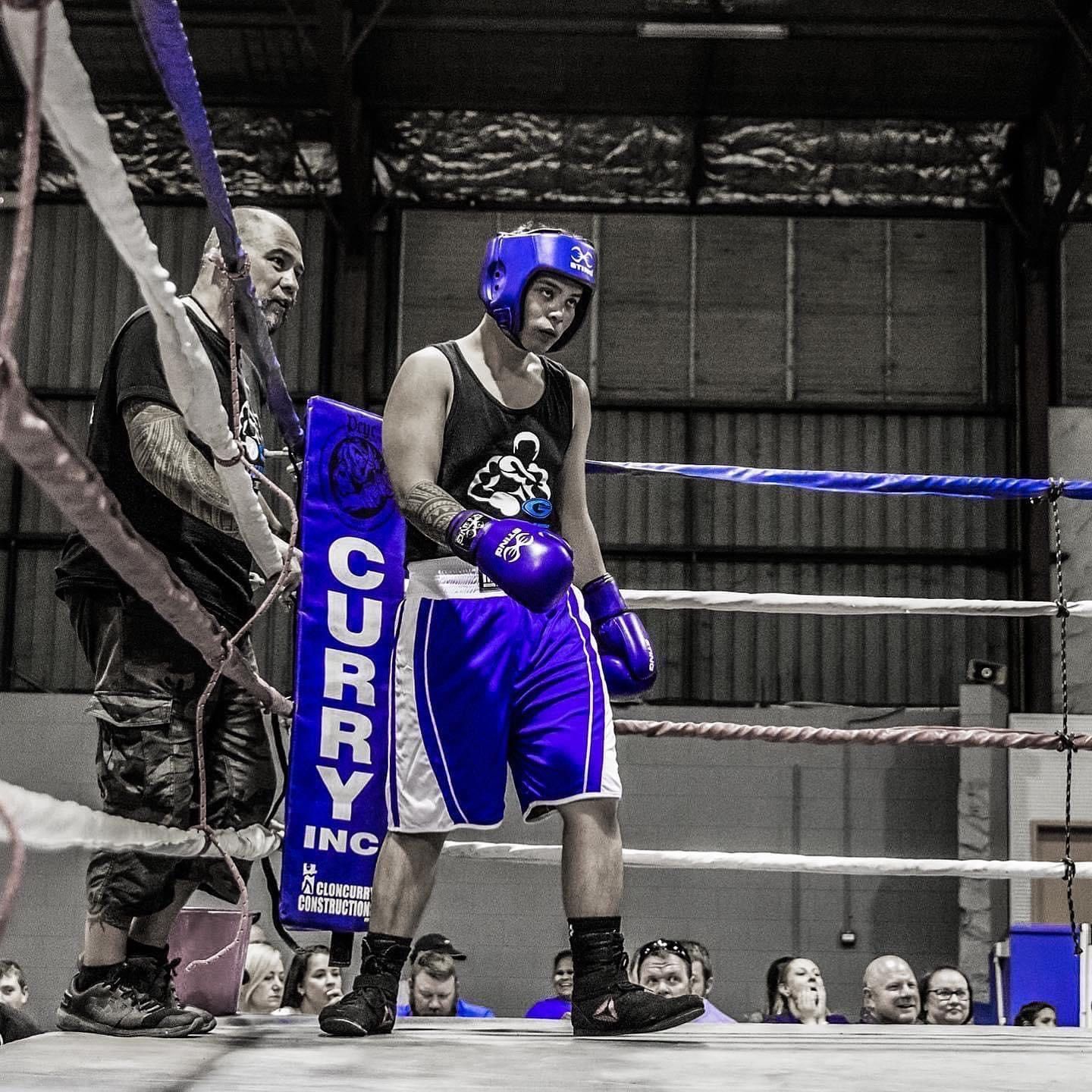 A man in a boxing ring with a sign that says curry on it
