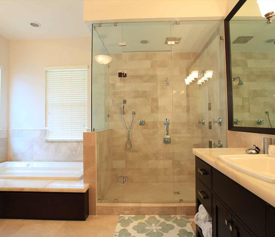 A bathroom with a walk in shower and a bathtub