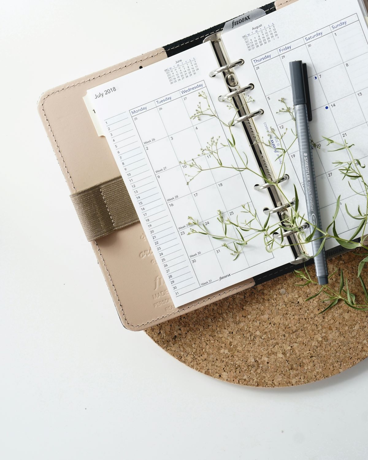 A person is writing on a checklist in a notebook.