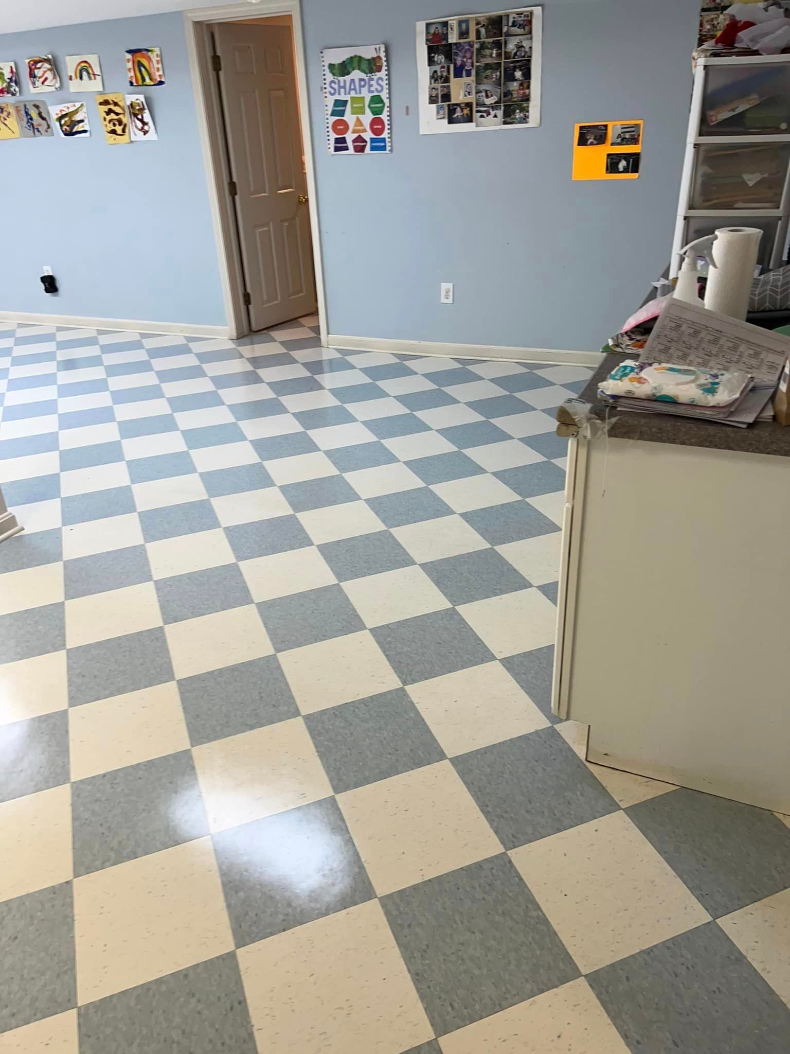 A room with a checkered floor and blue walls.