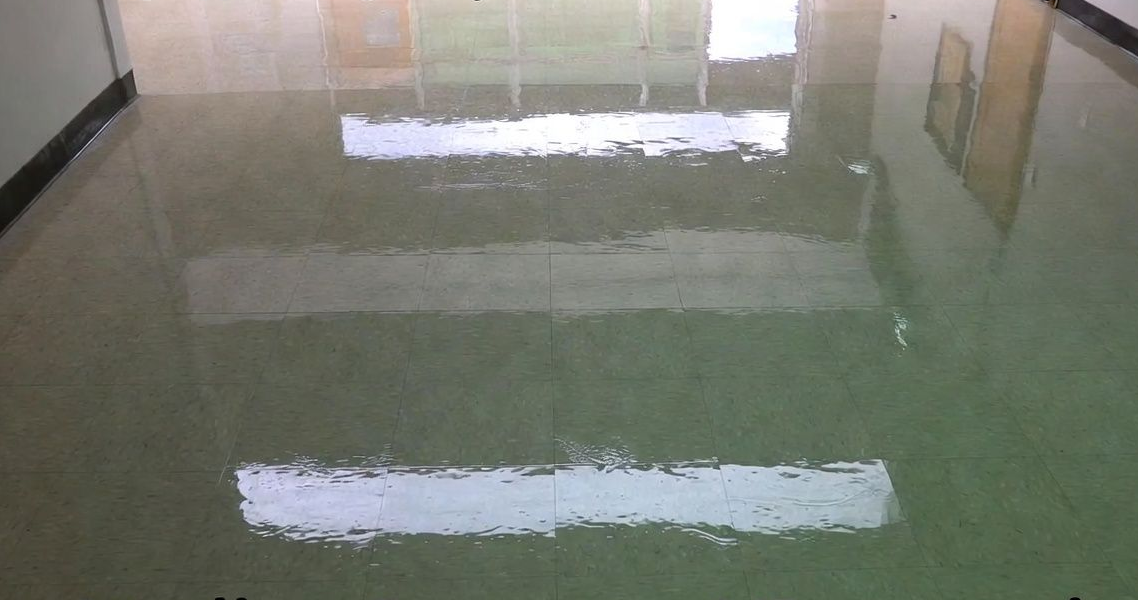 Shiny, polished floor with light reflections in a commercial setting.